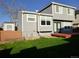 View of the home's backyard with a small red deck and shed surrounded by lush lawn and mature landscape at 292 S Pembrook St, Castle Rock, CO 80104