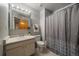 Bathroom featuring single vanity, medicine cabinet, and a shower-tub combo with a patterned shower curtain at 292 S Pembrook St, Castle Rock, CO 80104