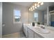Bathroom with a double vanity, large mirror, and a decorative light fixture, offering a bright and functional space at 292 S Pembrook St, Castle Rock, CO 80104