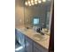 Bathroom featuring double sinks with white countertops and cabinets, paired with a large mirror at 292 S Pembrook St, Castle Rock, CO 80104