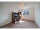 Bedroom featuring carpet flooring, a ceiling fan, a built in desk and shelving, and a window at 292 S Pembrook St, Castle Rock, CO 80104