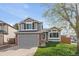Charming two-story home with grey siding, brick accents, a well-manicured lawn, and an attached two-car garage at 292 S Pembrook St, Castle Rock, CO 80104