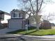 Well-manicured front lawn with an inviting two-story house and attached garage, ready for new homeowners at 292 S Pembrook St, Castle Rock, CO 80104