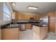 Kitchen features stainless steel appliances, granite countertops, a center island, and warm wood cabinetry at 292 S Pembrook St, Castle Rock, CO 80104