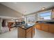 Kitchen with island, stainless sink, tile floor and eat in dining area with a large window at 292 S Pembrook St, Castle Rock, CO 80104