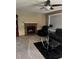 Cozy living room with a brick fireplace, ceiling fan, and comfortable black leather seating at 292 S Pembrook St, Castle Rock, CO 80104