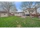 Spacious backyard featuring a well-manicured lawn, patio area, and mature landscaping at 5060 W 71St Pl, Westminster, CO 80030