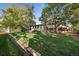 Beautifully landscaped backyard with mature trees, deck, shed, and lush lawn at 5060 W 71St Pl, Westminster, CO 80030