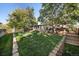 Beautifully landscaped backyard with mature trees, deck, shed, and lush lawn at 5060 W 71St Pl, Westminster, CO 80030