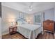 Bedroom featuring a ceiling fan, wood floors, and a decorative metal-framed bed at 5060 W 71St Pl, Westminster, CO 80030