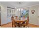 An eat-in kitchen nook boasts white cabinetry, glass display cases, and a window view at 5060 W 71St Pl, Westminster, CO 80030