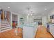 Open kitchen featuring a center island with pendant lighting and an attached table at 5060 W 71St Pl, Westminster, CO 80030