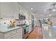 An eat-in kitchen features stainless steel appliances, white cabinets, and plenty of countertop space at 5060 W 71St Pl, Westminster, CO 80030