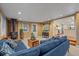 A living room showcases a wood-burning stove, a blue couch, and a glimpse into the kitchen at 5060 W 71St Pl, Westminster, CO 80030