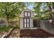 Backyard storage shed with painted siding, a gabled roof, brick walkway and a mulch garden bed at 5060 W 71St Pl, Westminster, CO 80030