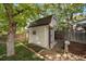 Backyard storage shed with painted siding, a gabled roof, and brick walkway with landscaped yard at 5060 W 71St Pl, Westminster, CO 80030