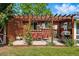 Inviting backyard patio features a wood pergola, seating, and a grill, ideal for outdoor relaxation and entertaining at 1395 S Kendall St, Lakewood, CO 80232