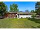 The exterior features a patio with a pergola, a well-kept lawn, and solar panels at 1395 S Kendall St, Lakewood, CO 80232