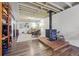 Finished basement area featuring a wood burning stove, exposed ceiling, and carpet at 1395 S Kendall St, Lakewood, CO 80232