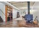 Finished basement area featuring a wood burning stove, exposed ceiling, and stair access at 1395 S Kendall St, Lakewood, CO 80232