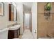 Bathroom features tile floors, a vanity, and a tiled shower at 1395 S Kendall St, Lakewood, CO 80232