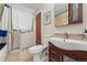 Bathroom with decorative tile flooring, white toilet, and modern vanity at 1395 S Kendall St, Lakewood, CO 80232