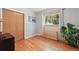 Bright bedroom features hardwood floors, a window with natural light, and closet for ample storage at 1395 S Kendall St, Lakewood, CO 80232