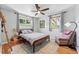 Cozy bedroom featuring hardwood floors, a ceiling fan, and neutral tones with two windows and seating at 1395 S Kendall St, Lakewood, CO 80232