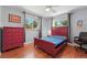 Bedroom featuring hardwood floors, colorful furniture, a ceiling fan, and natural light through large windows at 1395 S Kendall St, Lakewood, CO 80232