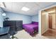 Cozy bedroom featuring neutral carpet, light blue walls, and a purple bedspread at 1395 S Kendall St, Lakewood, CO 80232