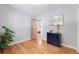 Bedroom boasts hardwood floors and neutral paint and an open door to another room at 1395 S Kendall St, Lakewood, CO 80232