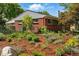 Lovely brick home surrounded by lush landscaping, enhancing its curb appeal and creating a serene outdoor space at 1395 S Kendall St, Lakewood, CO 80232