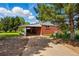 Brick home with a covered carport area and a concrete driveway leading to the side entrance, offering convenient parking at 1395 S Kendall St, Lakewood, CO 80232
