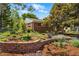 Charming brick home with a beautifully landscaped front yard and garden featuring stone accents and vibrant foliage at 1395 S Kendall St, Lakewood, CO 80232