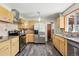 Updated kitchen features stainless steel appliances, granite counters, wood cabinets, and modern flooring at 1395 S Kendall St, Lakewood, CO 80232