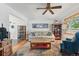 Cozy living room with neutral sofa, wood coffee table, and a large window with natural light at 1395 S Kendall St, Lakewood, CO 80232