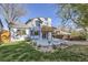Back of the house featuring a walk out deck, patio, and large lush yard with rock landscaping at 11892 Vallejo St, Denver, CO 80234