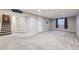 Finished basement with carpet, window, and shelving at 11892 Vallejo St, Denver, CO 80234