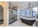 Bathroom featuring luxurious shower and free-standing black soaking tub next to the window at 11892 Vallejo St, Denver, CO 80234
