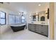 Modern bathroom featuring a freestanding tub, double sink vanity, and updated fixtures at 11892 Vallejo St, Denver, CO 80234