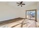 Bedroom featuring wood floors, a ceiling fan, and access to a private balcony with views of nature at 11892 Vallejo St, Denver, CO 80234