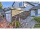 Exterior view of the house featuring a brick facade, solar panels, and a well maintained yard at 11892 Vallejo St, Denver, CO 80234
