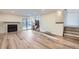 Open living room with a stone fireplace and sliding glass doors to the back patio at 11892 Vallejo St, Denver, CO 80234