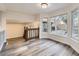 Open living area with large windows providing natural light and wood laminate flooring at 11892 Vallejo St, Denver, CO 80234