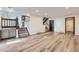 Spacious living area with multiple access points and wood laminate flooring at 11892 Vallejo St, Denver, CO 80234