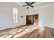 Bright, spacious living room with hardwood floors and decorative ceiling fan, perfect for entertaining and relaxing at 11892 Vallejo St, Denver, CO 80234