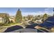 Neighborhood street view featuring mature landscaping, sidewalks, and mountain views at 11892 Vallejo St, Denver, CO 80234