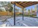 Covered concrete patio featuring dark metal support beams overlooking a fenced in backyard at 11892 Vallejo St, Denver, CO 80234
