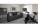 Basement with an exercise bike, comfortable couch, and organized storage at 13777 W Amherst Way, Lakewood, CO 80228