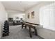 Finished basement featuring an exercise area, couch, and shuffleboard table at 13777 W Amherst Way, Lakewood, CO 80228